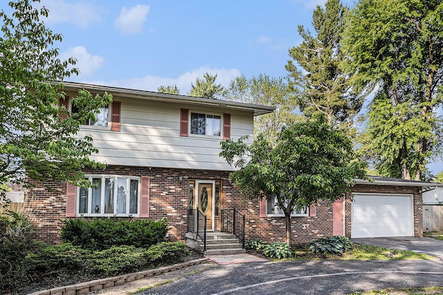 29 Douglas Ave, Coldwater, MI 49036 - colonial inspired home with an attached garage, asphalt driveway, and brick siding