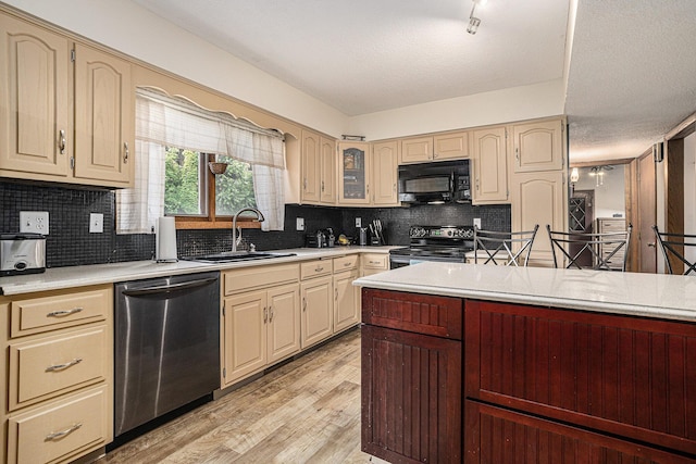 29 Douglas Ave, Coldwater, MI 49036 - kitchen featuring black appliances, light countertops, light wood-style flooring, and tasteful backsplash
