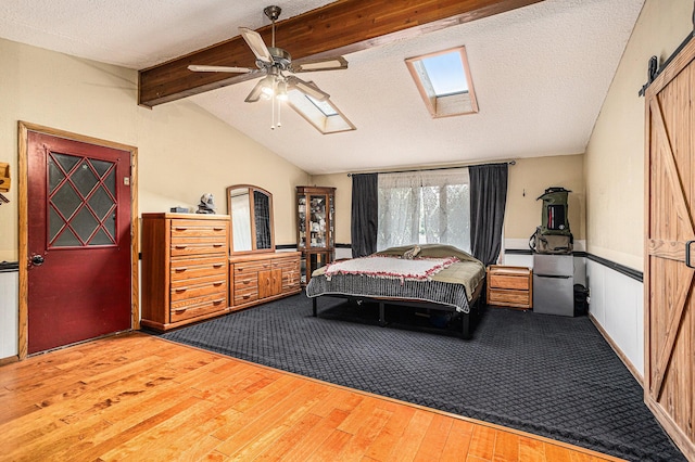 29 Douglas Ave, Coldwater, MI 49036 - bedroom featuring wood finished floors, a skylight, a textured ceiling, and ceiling fan