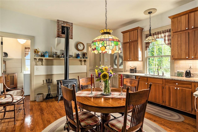 14011 Verona Rd, Marshall, MI 49068 - dining room with a wood stove and dark wood-style flooring