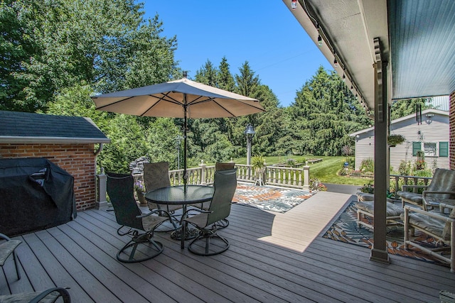 14011 Verona Rd, Marshall, MI 49068 - deck featuring outdoor dining area, an outdoor structure, a grill, and a lawn