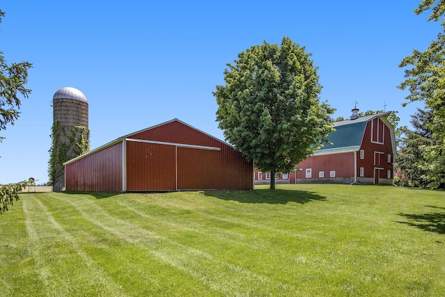 14011 Verona Rd, Marshall, MI 49068 - view of green lawn with an outdoor structure, a barn, a garage, and a pole building