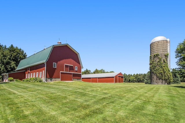 14011 Verona Rd, Marshall, MI 49068 - view of green lawn featuring a barn, a detached garage, and an outbuilding
