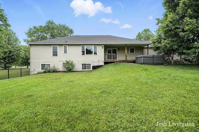 9337 Andrew Farms Dr, Alto, MI 49302 - rear view of house featuring a hot tub and a wooden deck
