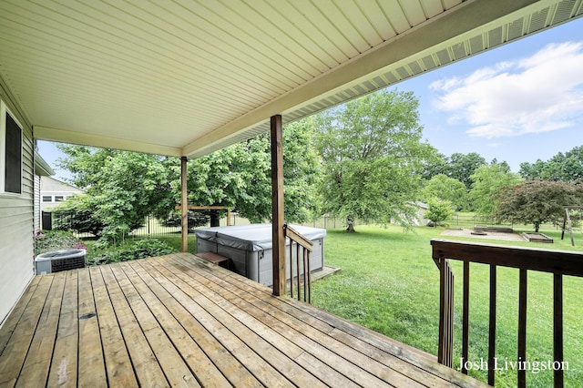 9337 Andrew Farms Dr, Alto, MI 49302 - wooden deck featuring a hot tub, a fenced backyard, and view of scattered trees