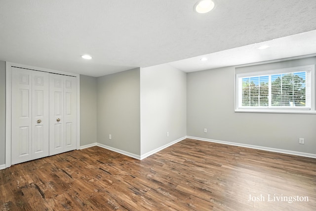 9337 Andrew Farms Dr, Alto, MI 49302 - unfurnished bedroom with wood finished floors and recessed lighting