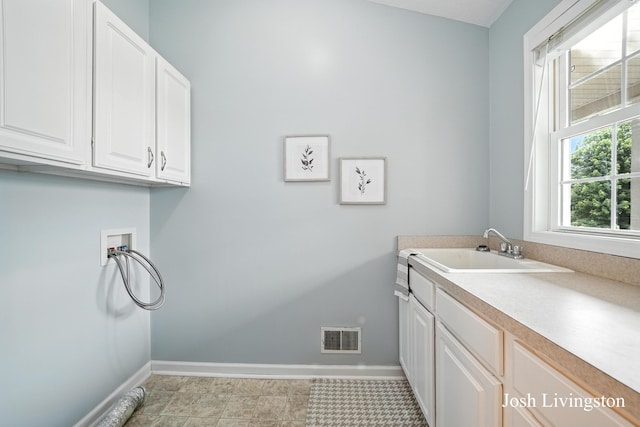 9337 Andrew Farms Dr, Alto, MI 49302 - washroom with washer hookup and cabinet space