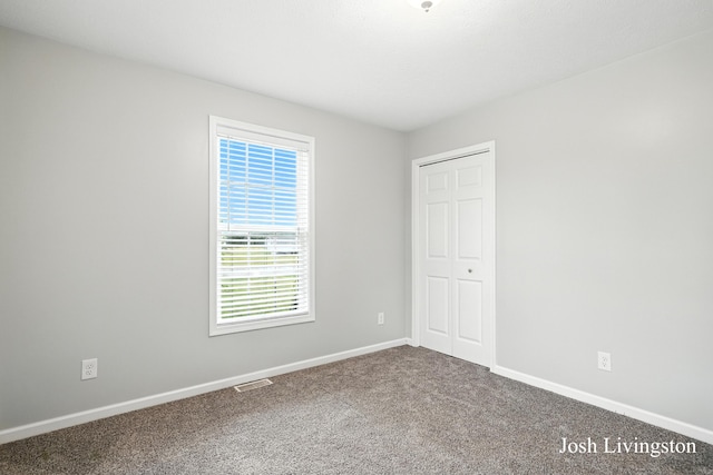 9337 Andrew Farms Dr, Alto, MI 49302 - unfurnished bedroom with carpet and a closet