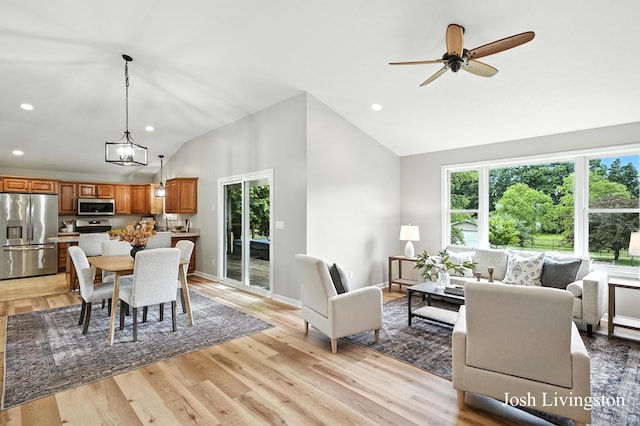 9337 Andrew Farms Dr, Alto, MI 49302 - dining room featuring lofted ceiling, recessed lighting, light wood-style floors, and a ceiling fan