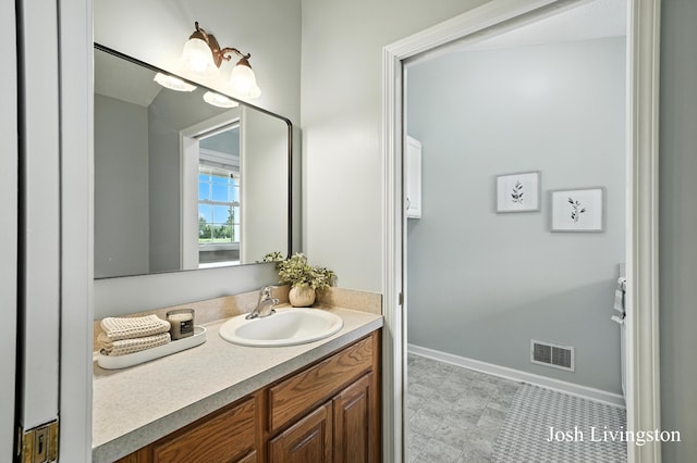 9337 Andrew Farms Dr, Alto, MI 49302 - bathroom featuring vanity and baseboards
