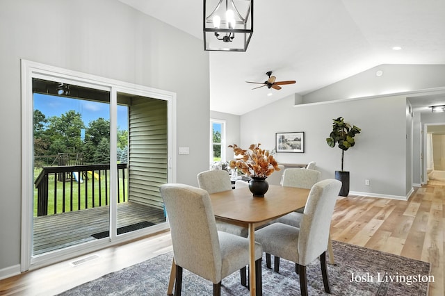 9337 Andrew Farms Dr, Alto, MI 49302 - dining area with lofted ceiling, light wood-style floors, plenty of natural light, ceiling fan, and a chandelier