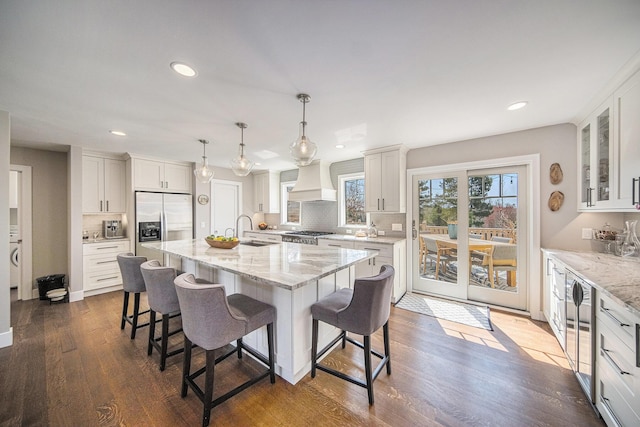 3189 Textile Rd, Saline, MI 48176 - kitchen featuring appliances with stainless steel finishes, a breakfast bar, recessed lighting, backsplash, and dark wood-type flooring