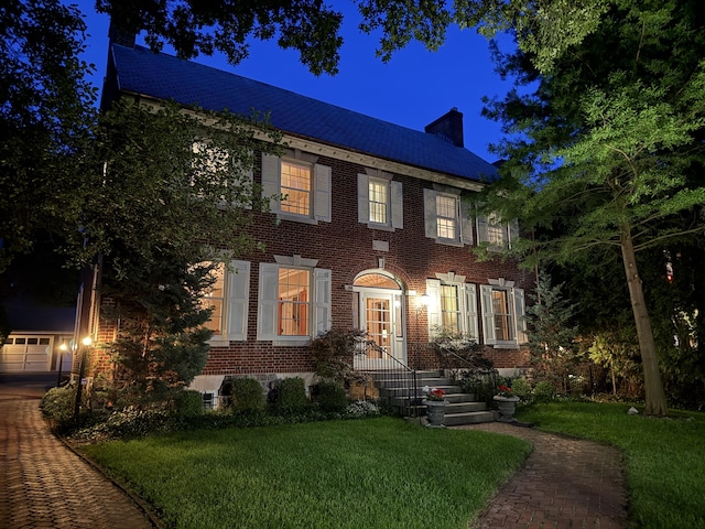 60 Lafayette Ave NE, Grand Rapids, MI 49503 - colonial inspired home with a chimney, brick siding, and a lawn