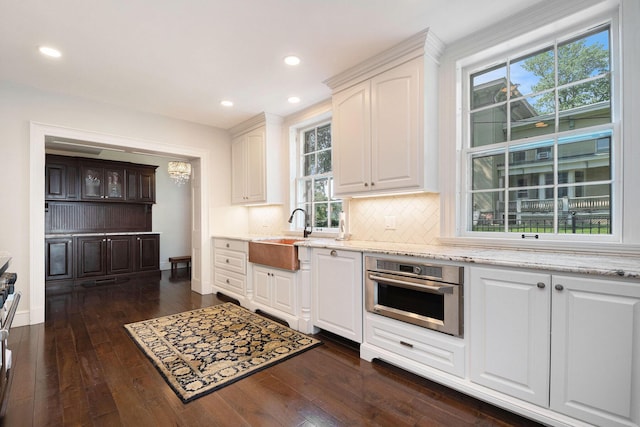 60 Lafayette Ave NE, Grand Rapids, MI 49503 - kitchen featuring appliances with stainless steel finishes, white cabinetry, backsplash, recessed lighting, and dark wood-style flooring