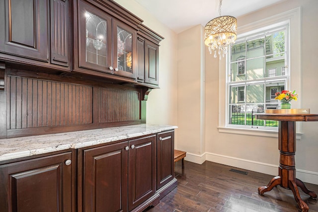 60 Lafayette Ave NE, Grand Rapids, MI 49503 - bar with dark wood finished floors, a chandelier, and decorative light fixtures