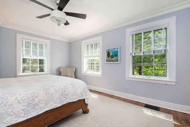 60 Lafayette Ave NE, Grand Rapids, MI 49503 - bedroom with crown molding, multiple windows, wood finished floors, and ceiling fan