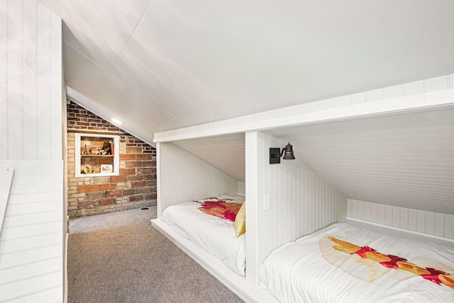 60 Lafayette Ave NE, Grand Rapids, MI 49503 - bedroom with lofted ceiling, carpet floors, brick wall, and wooden walls