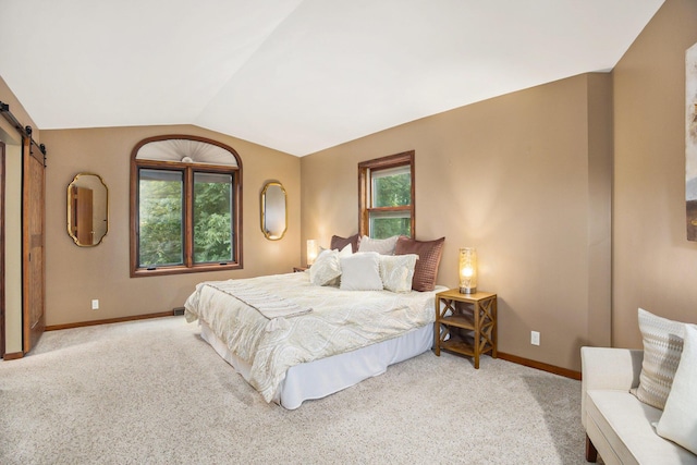 2766 48th Ave, Zeeland, MI 49464 - bedroom with a barn door, light colored carpet, and vaulted ceiling