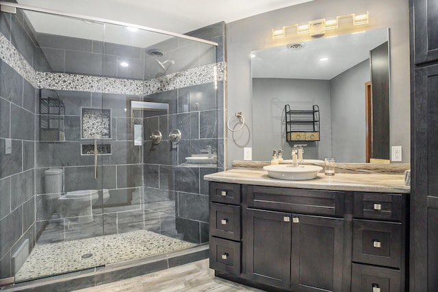 2766 48th Ave, Zeeland, MI 49464 - bathroom with a tile shower, vanity, and wood finished floors