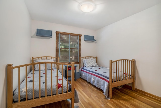 6368 E Lake Ln, Sawyer, MI 49125 - bedroom with wood finished floors and a wall unit AC