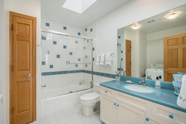 6368 E Lake Ln, Sawyer, MI 49125 - bathroom with washer / dryer, a skylight, speckled floor, vanity, and bath / shower combo with glass door
