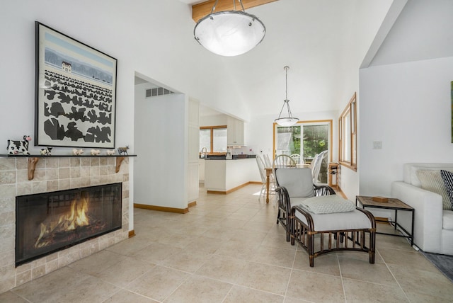 6368 E Lake Ln, Sawyer, MI 49125 - living area featuring vaulted ceiling, a glass covered fireplace, and light tile patterned floors
