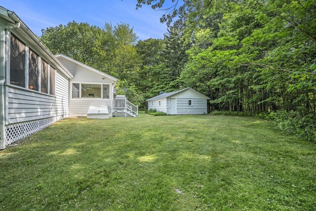 6368 E Lake Ln, Sawyer, MI 49125 - view of grassy yard featuring an outdoor structure and a sunroom