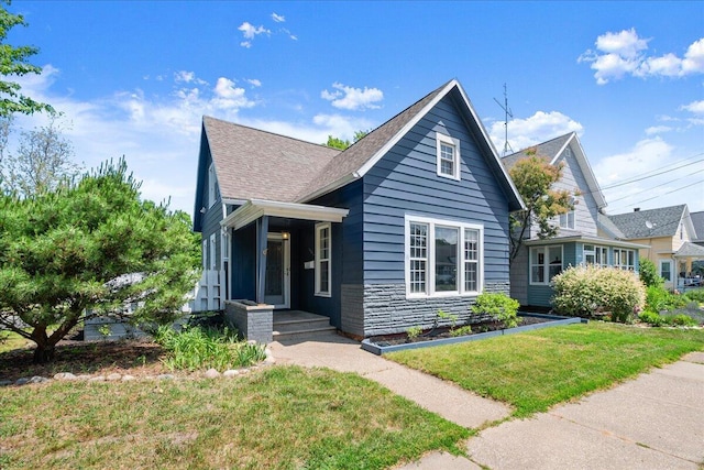 905 Harrison Ave, Saint Joseph, MI 49085 - bungalow-style house featuring a front lawn, stone siding, and a shingled roof