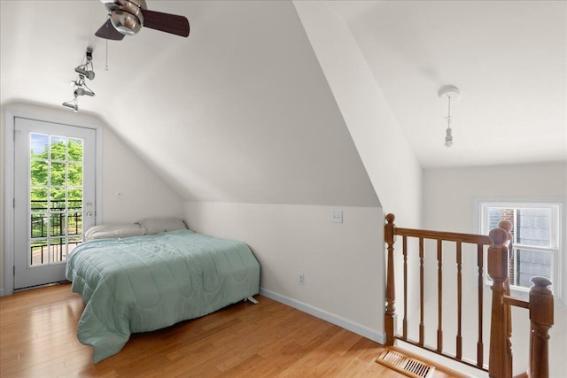 905 Harrison Ave, Saint Joseph, MI 49085 - bedroom featuring access to exterior, track lighting, lofted ceiling, and light wood-style flooring