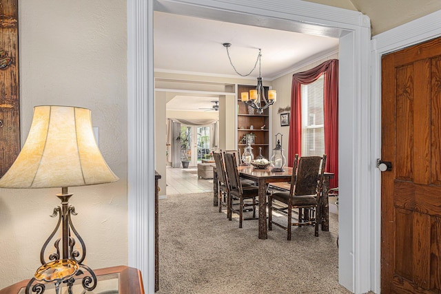 209 Maple St, Three Oaks, MI 49128 - carpeted dining room with a chandelier, ornamental molding, and ceiling fan