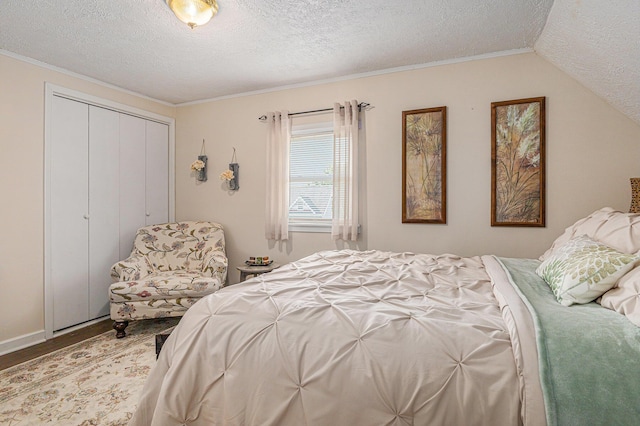 209 Maple St, Three Oaks, MI 49128 - bedroom featuring a textured ceiling, wood finished floors, a closet, and crown molding