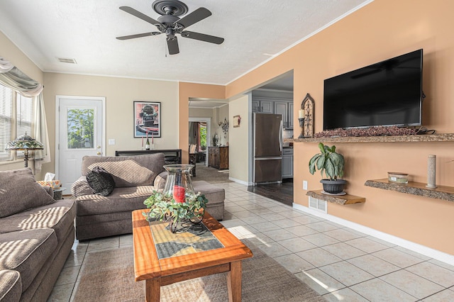 209 Maple St, Three Oaks, MI 49128 - living room with light tile patterned flooring, healthy amount of natural light, ceiling fan, a textured ceiling, and crown molding