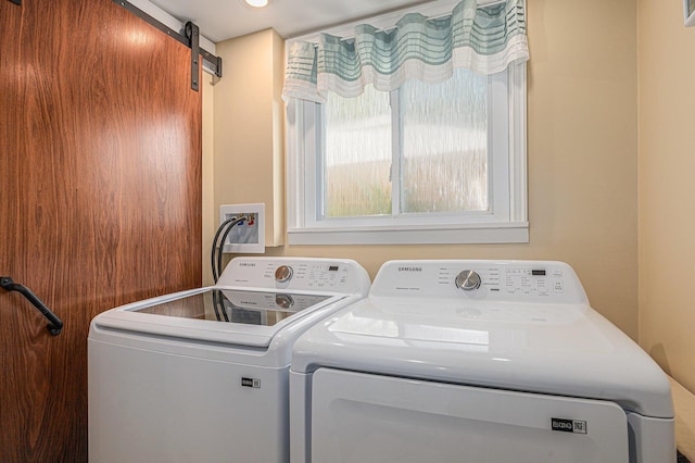209 Maple St, Three Oaks, MI 49128 - washroom featuring separate washer and dryer and a barn door
