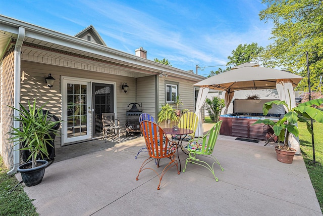 209 Maple St, Three Oaks, MI 49128 - view of patio / terrace with a hot tub, a gazebo, and outdoor dining area
