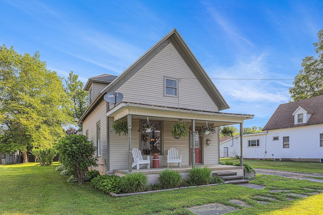 209 Maple St, Three Oaks, MI 49128 - view of front facade with covered porch and a front yard