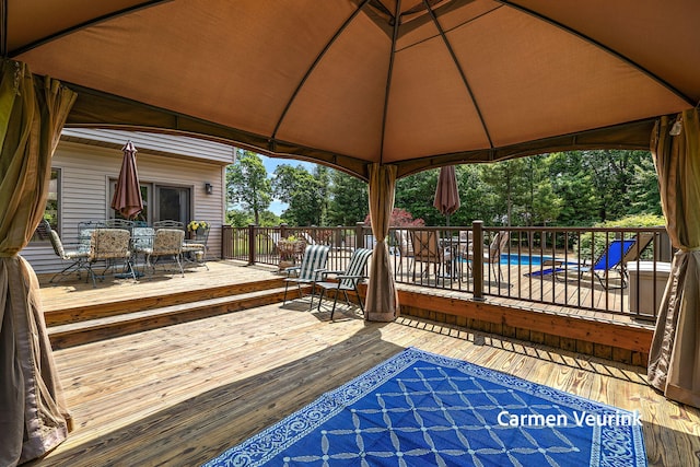 1723 S Sullivan Rd, Ravenna, MI 49451 - deck featuring outdoor dining area and a gazebo