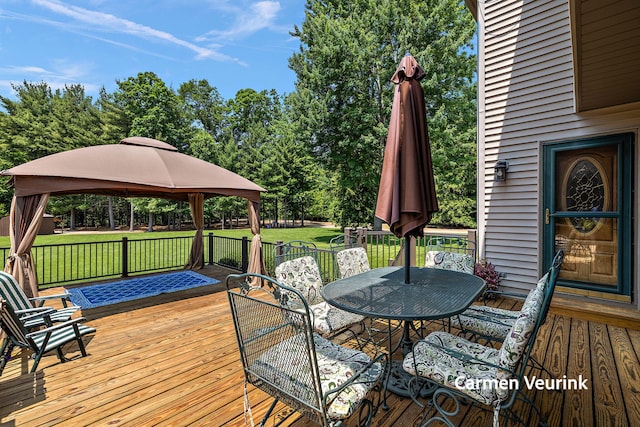 1723 S Sullivan Rd, Ravenna, MI 49451 - deck featuring a gazebo, a yard, and outdoor dining area
