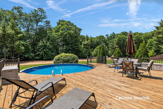1723 S Sullivan Rd, Ravenna, MI 49451 - swimming pool with a wooden deck and outdoor dining area