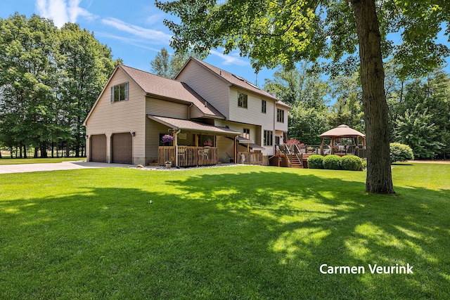 1723 S Sullivan Rd, Ravenna, MI 49451 - view of front of home with a gazebo, driveway, a front lawn, a garage, and a porch