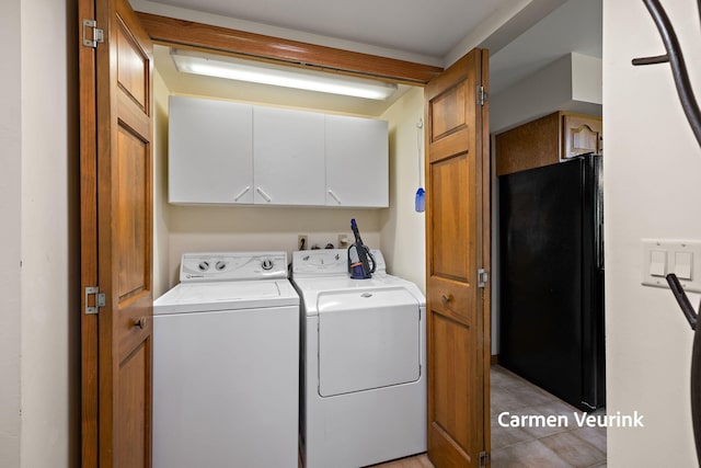 1723 S Sullivan Rd, Ravenna, MI 49451 - laundry area with separate washer and dryer, cabinet space, and light tile patterned flooring
