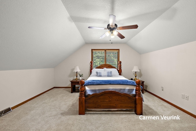 1723 S Sullivan Rd, Ravenna, MI 49451 - carpeted bedroom featuring vaulted ceiling, ceiling fan, and a textured ceiling