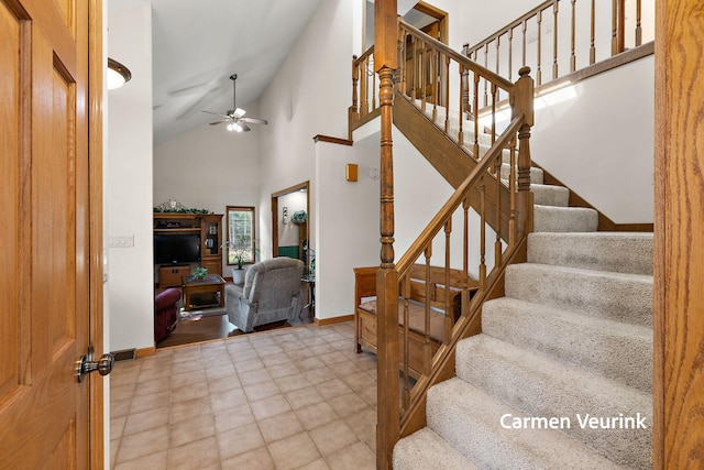 1723 S Sullivan Rd, Ravenna, MI 49451 - stairs with a ceiling fan and high vaulted ceiling