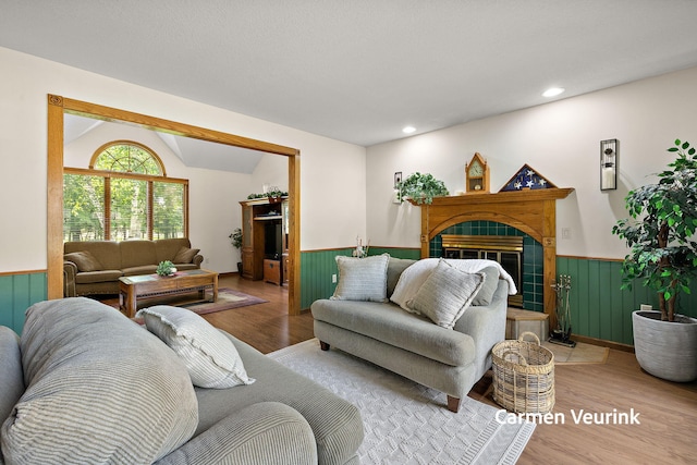 1723 S Sullivan Rd, Ravenna, MI 49451 - living room featuring wainscoting, light wood-style floors, a fireplace, recessed lighting, and wooden walls