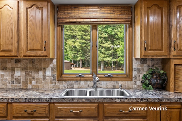 1723 S Sullivan Rd, Ravenna, MI 49451 - kitchen with brown cabinets, backsplash, and dark countertops