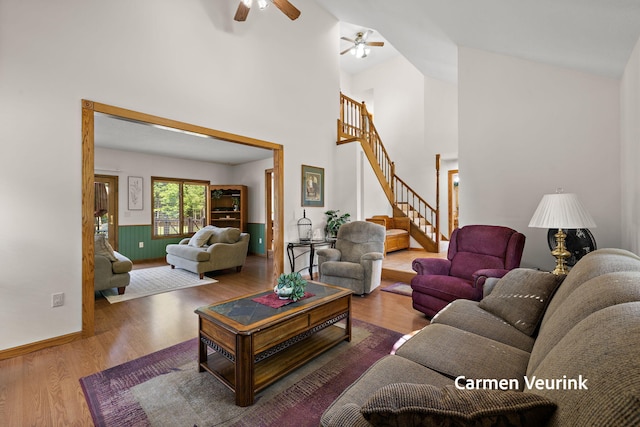 1723 S Sullivan Rd, Ravenna, MI 49451 - living room with wood finished floors, stairway, ceiling fan, and high vaulted ceiling