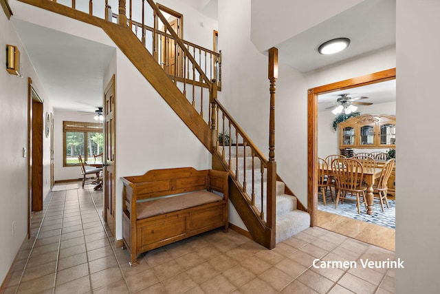 1723 S Sullivan Rd, Ravenna, MI 49451 - stairs featuring ceiling fan and tile patterned flooring
