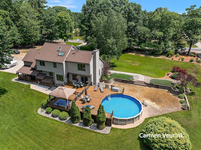 1723 S Sullivan Rd, Ravenna, MI 49451 - swimming pool with a wooden deck and outdoor dining area