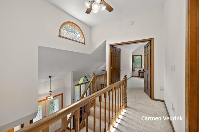1723 S Sullivan Rd, Ravenna, MI 49451 - hall featuring an upstairs landing, light carpet, and high vaulted ceiling
