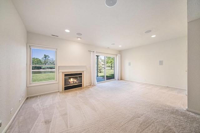 3350 Breckland Ct, Ann Arbor, MI 48108 - unfurnished living room with carpet floors, a fireplace with flush hearth, and recessed lighting