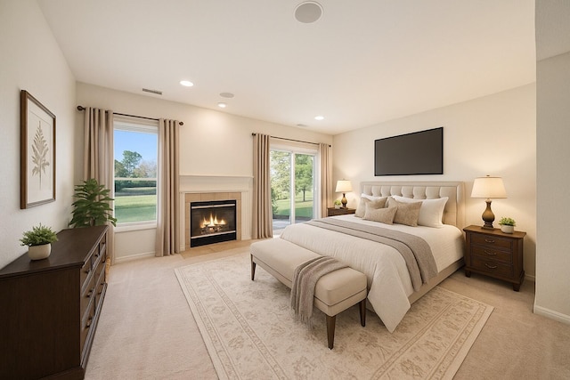 3350 Breckland Ct, Ann Arbor, MI 48108 - bedroom featuring light carpet, a tiled fireplace, and recessed lighting